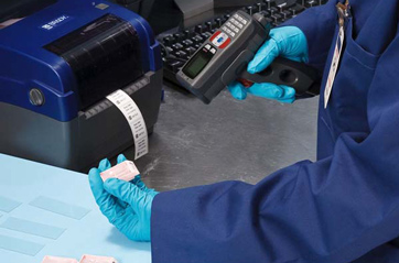 A scientist employs a scanner to verify the ID number of a sample, ensuring accurate tracking and data management.