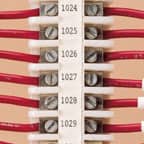 Una serie de etiquetas de bloque de terminales Brady aplicadas a un bloque de terminales para identificar cada terminal numerado.